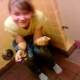 A girl pisses into a trash can because all of the toilets are occupied. Very brief video.
